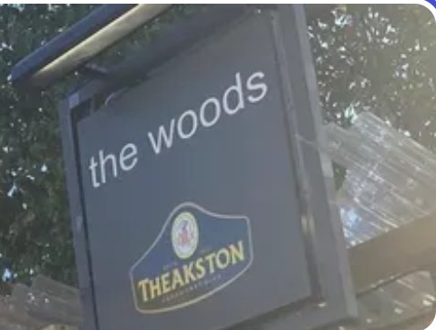 The Woods pub sign